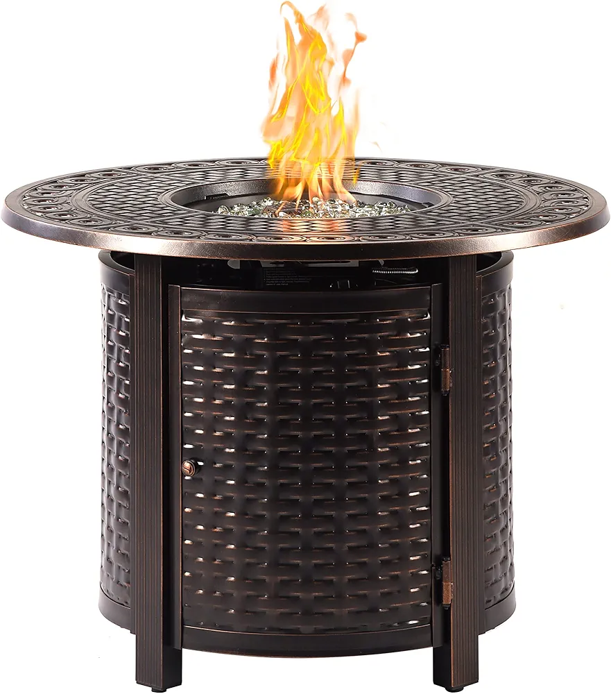 Ornate propane round fire pit table made of rust-free cast aluminum with an antique copper finish, featuring clear fire glass, a table lid, propane tank cover, foot glides, and protective fabric cover — measures 34 x 34 x 24.5 inches with a 37,000 BTU heat output."